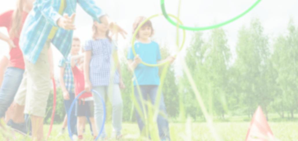 A group of people standing around in the grass.