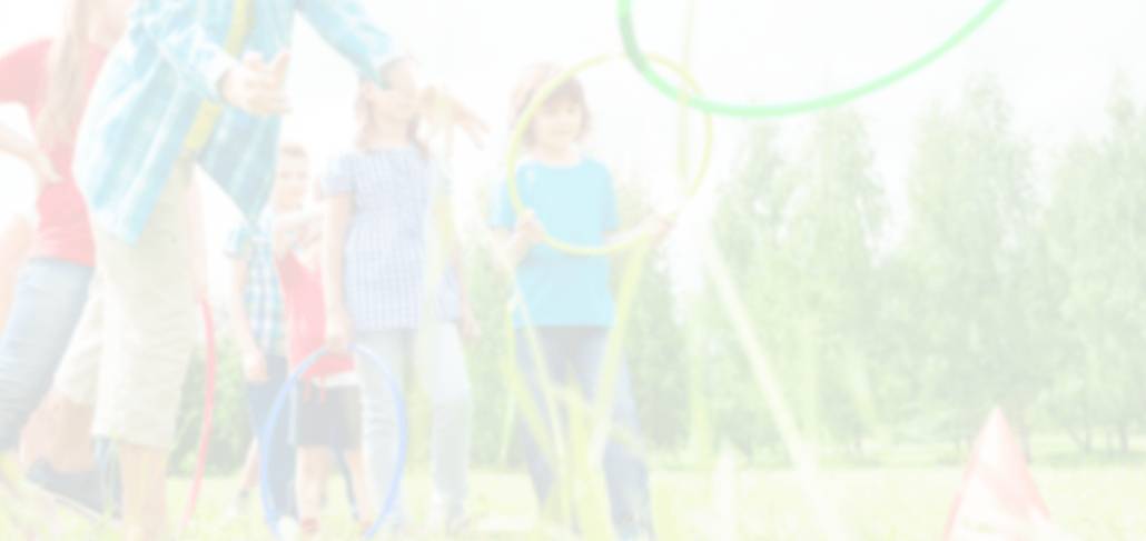 A blurry image of people standing in the grass.
